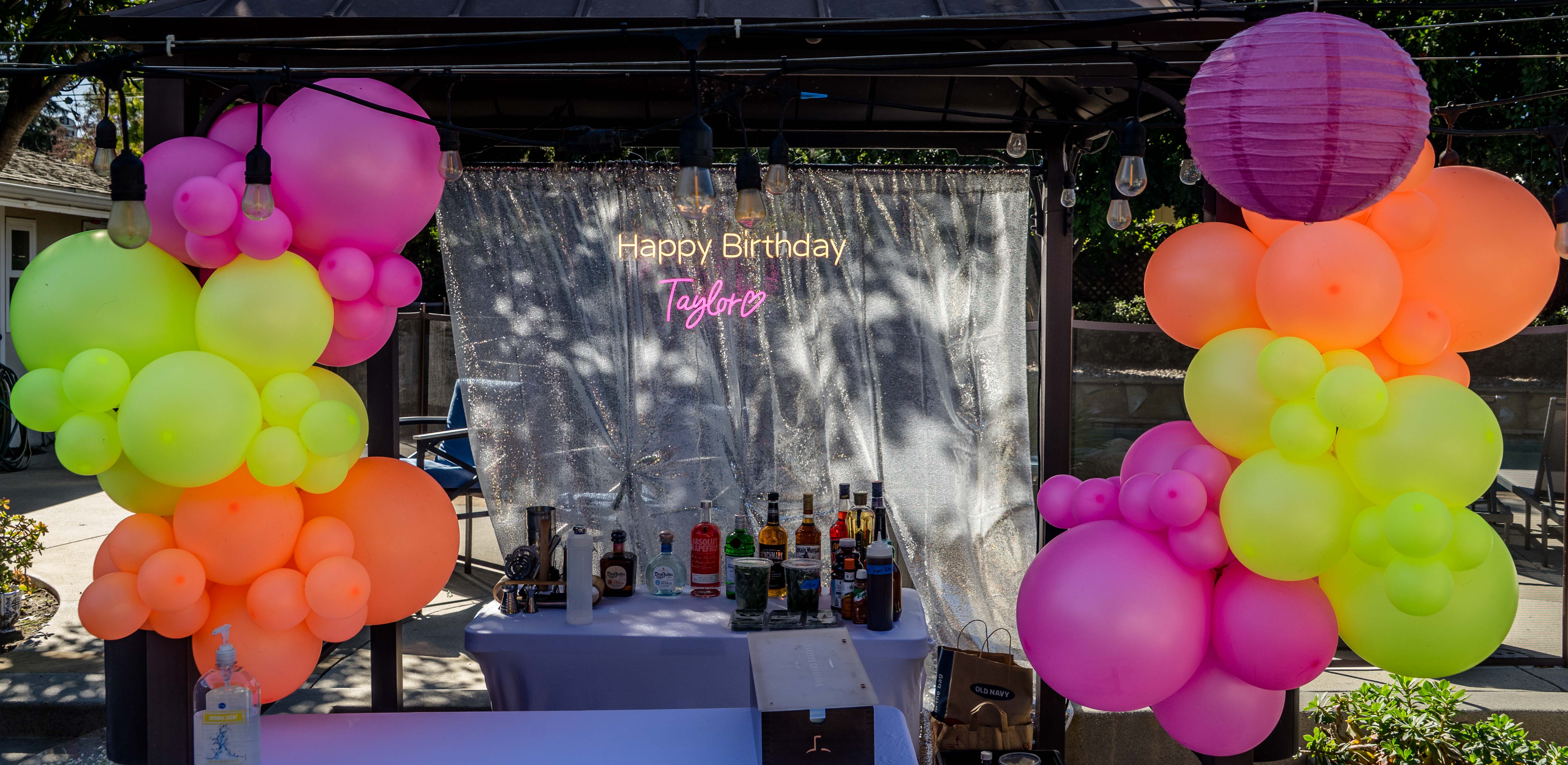 Bar setup with colorful balloons at a La Carreta event